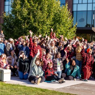 Group of NMU faculty and staff dressed in plaid