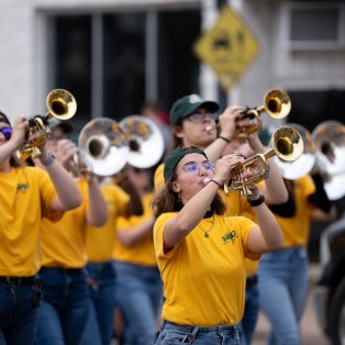 NMU marching band playing at a parade