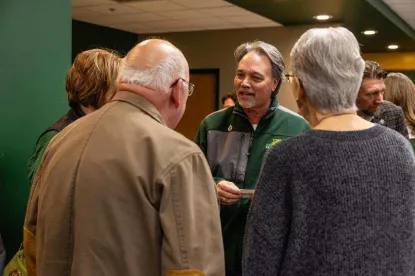 President Chris Olsen conversing with employees