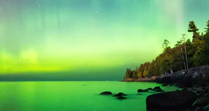 Northern Lights illuminating the shoreline of Lake Superior near NMU
