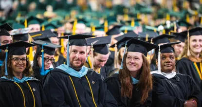 Master's graduates in robes at commencement ceremony
