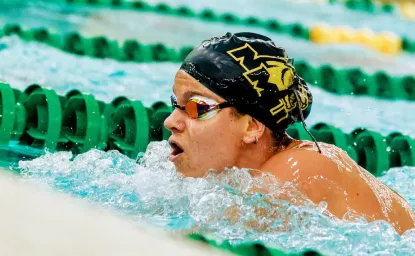 NMU Swim Team member in the water during a meet