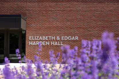 Harden Hall red brick exterior with purple flowers