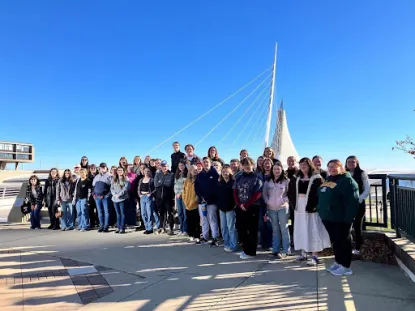 Group of Honors students standing outdoors at the Burke Brise Soleil.