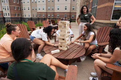 Students playing Jinga on The Lodge patio