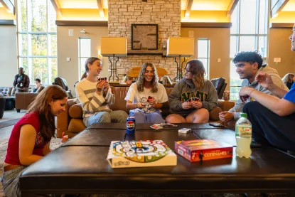 Students playing a boardgame in the lodge