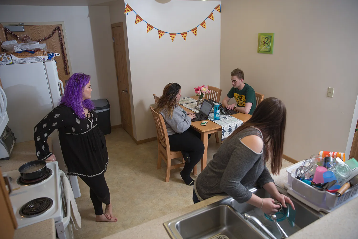 Students hanging out in a Woodland apartment