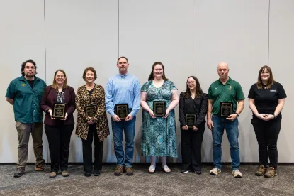 Photograph of all 8 Excellence in Service award winners. Names are listed below this photo.