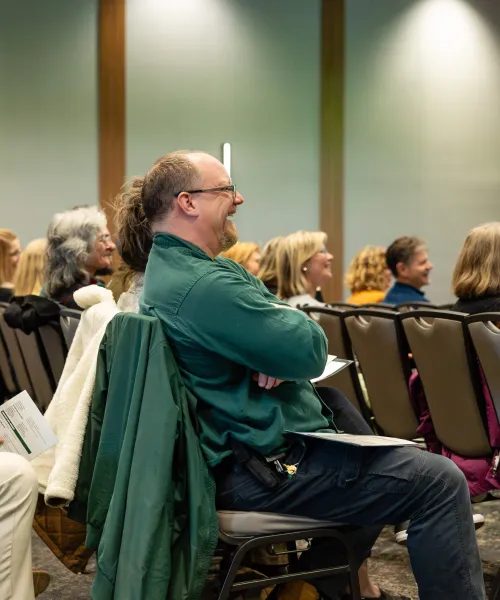 Photo of some of the crowd laughing during a speech