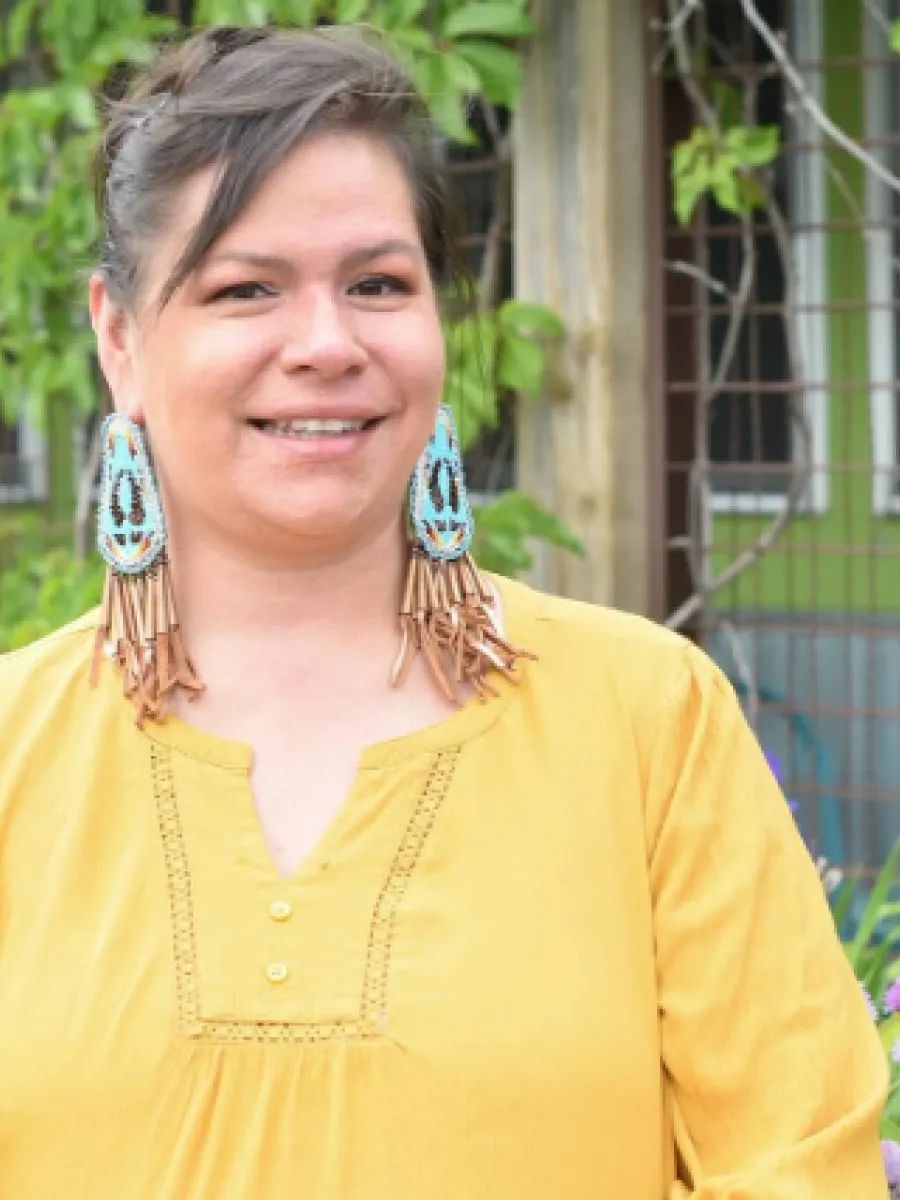 Pamela Valdez smiling while wearing a yellow shirt. 