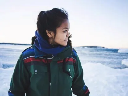 International Student standing by frozen lake 