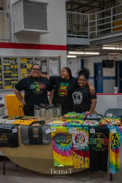 A table giving out Juneteenth themed shirts and merch, at the 2025 Juneteenth Celebration.