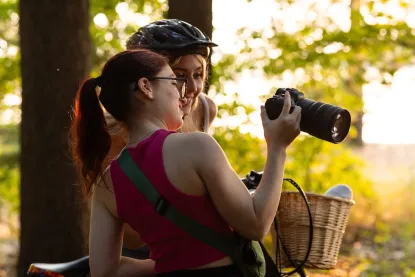 Two girls looking at a camera while outdoors