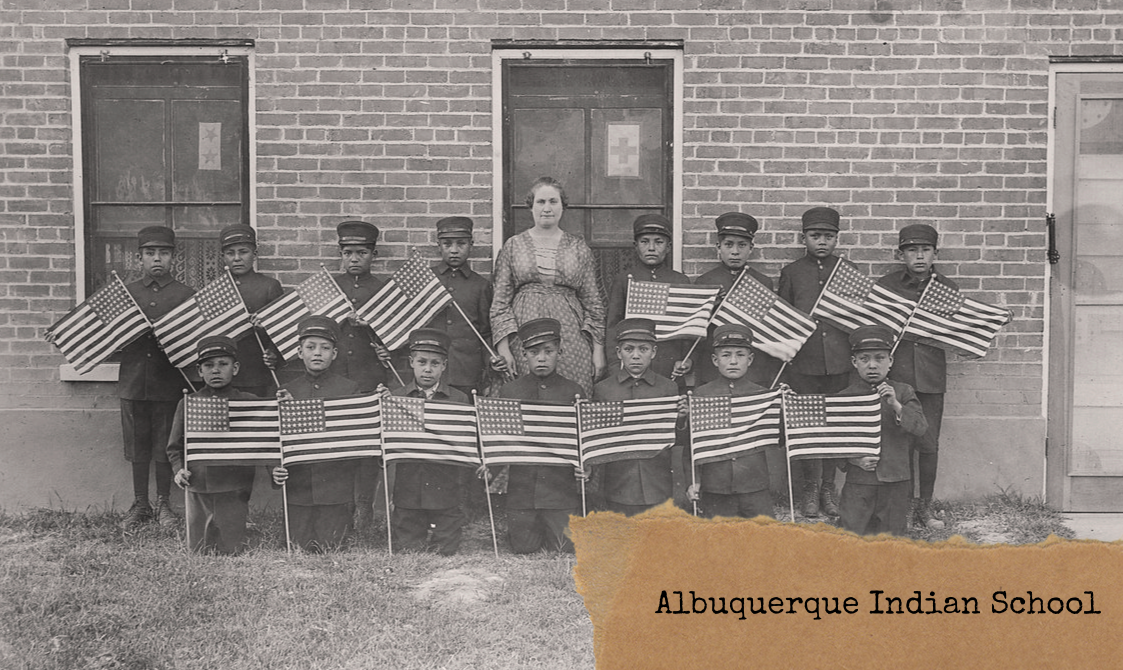 Department of the Interior. Bureau of Indian Affairs. Albuquerque Indian School. (1947 - ca. 1964) Title	 Very early class of young boys with flags at the Albuquerque Indian School.  Source:  Department of the Interior. Bureau of Indian Affairs. Albuquerque Indian School. (1947 - ca. 1964)