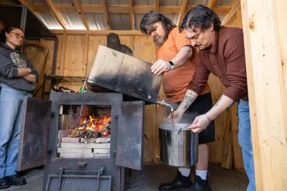 A group of Native Americans working in the sugar shack to gather maple syrup