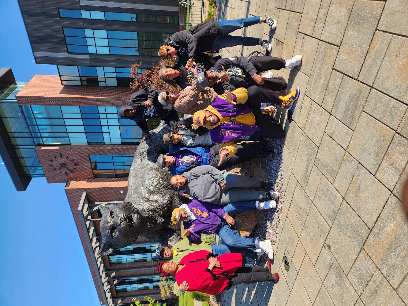 Large group in front of Wildcat Statue on campus