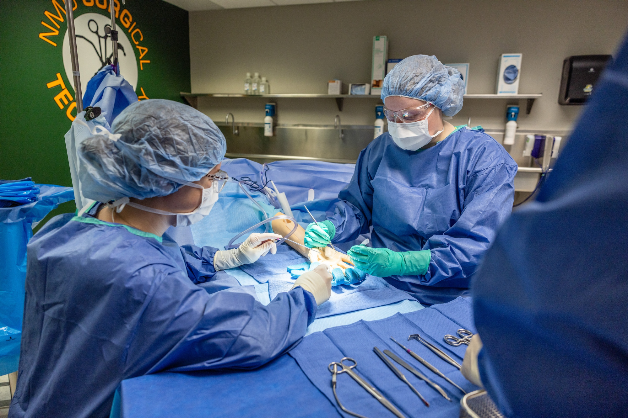 Surgical Technology students fully scrubbed up work in the surgery simulation lab at NMU