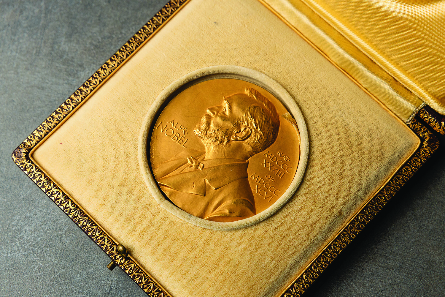 Circular gold medal in yellow velvet case with relief of "Alfr. Nobel" and the year in Roman numerals