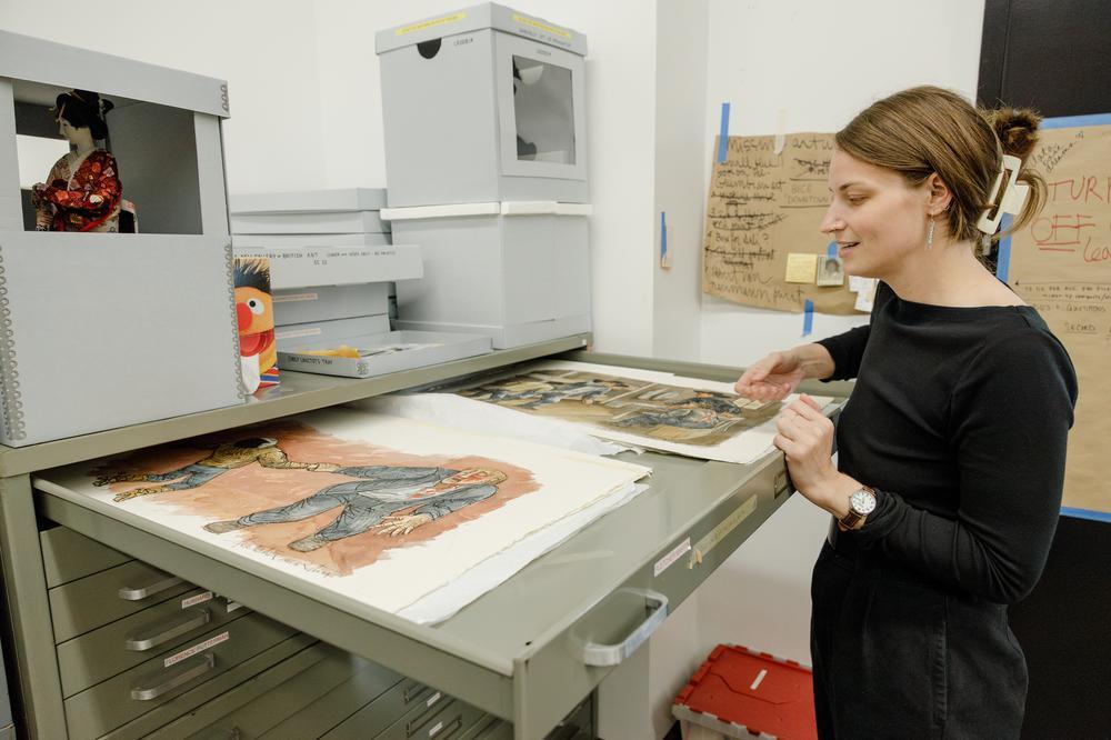 Woman looking at artwork in drawer