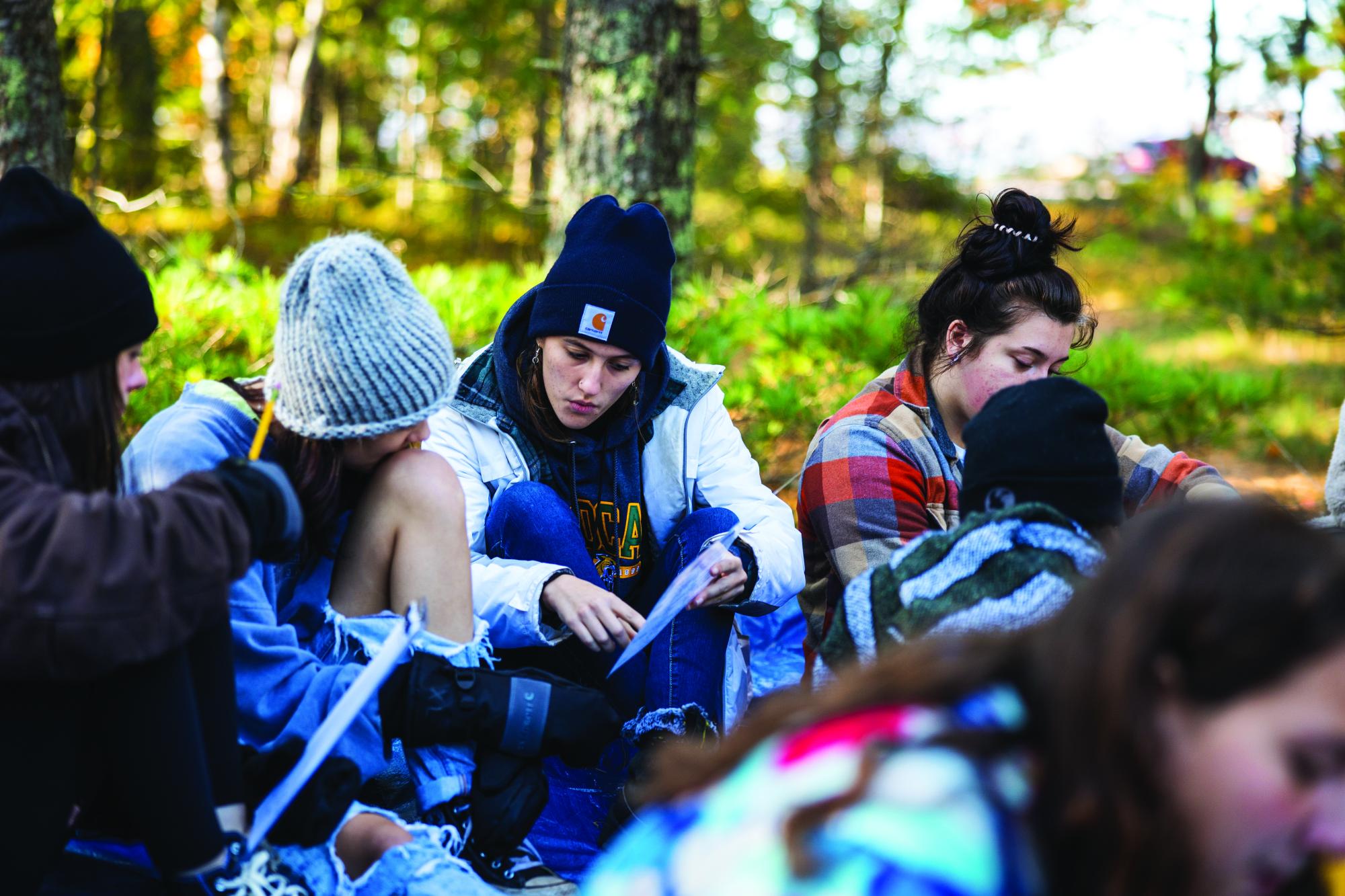 Students learning in a wooded environment