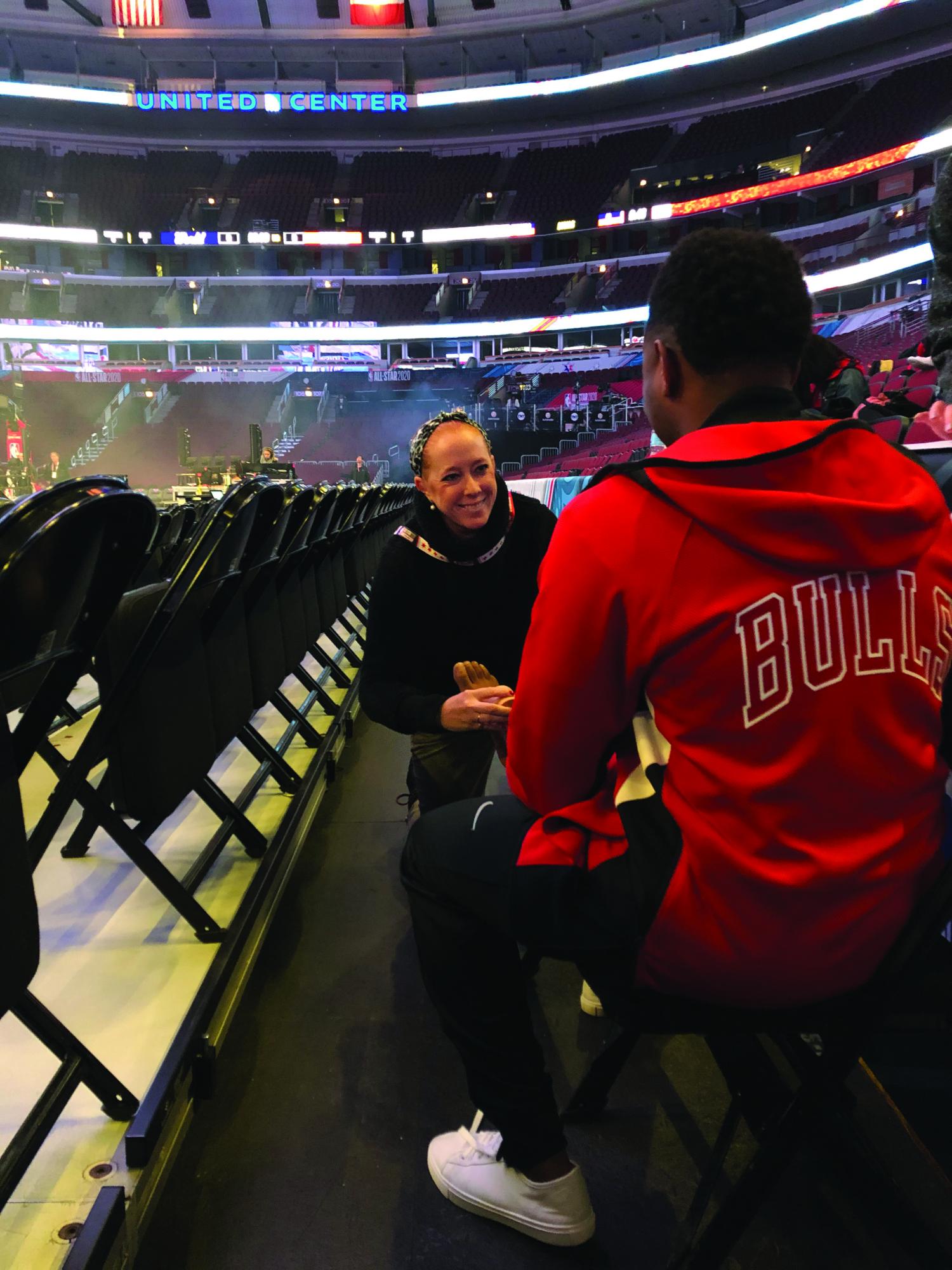 Meg Schneider helping an injured Chicago Bulls player