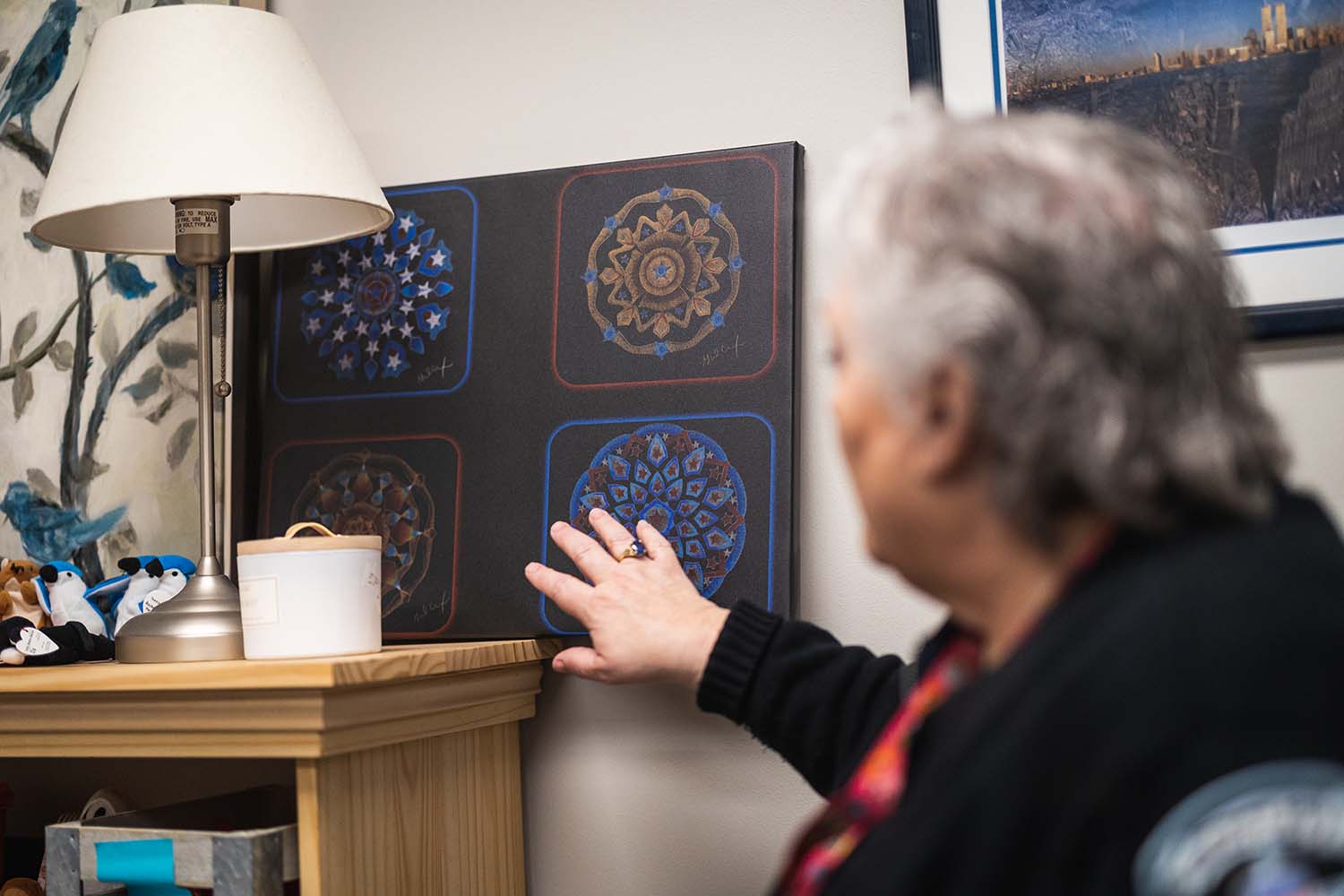 Juzwin pointing to artwork on the wall