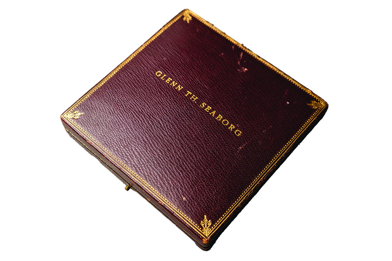Leather case containing Nobel medal with gold embossing reading "Glenn Th. Seaborg"