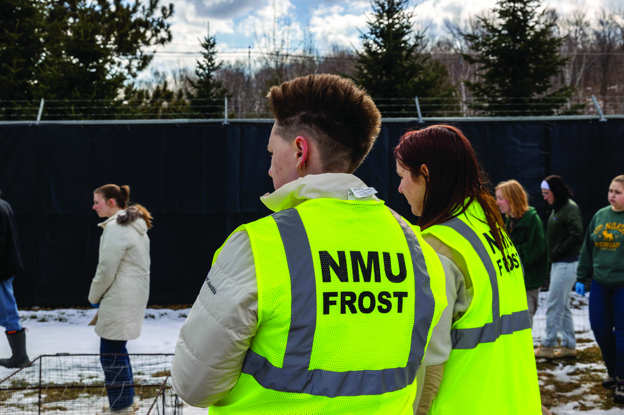 Students in fluorescent NMU FROST vests at the outdoor site
