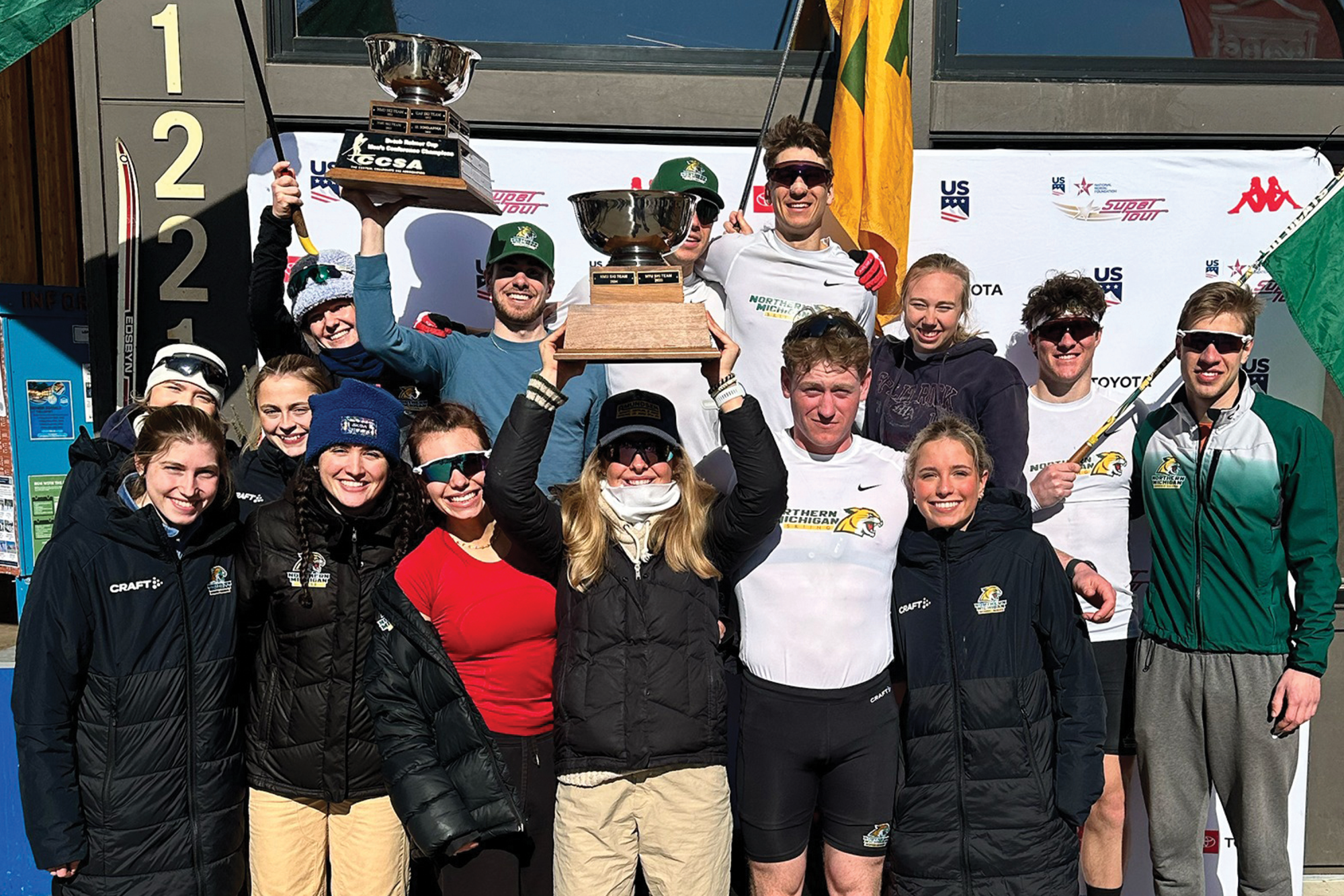 NMU's Nordic Ski Team holding a torphy.