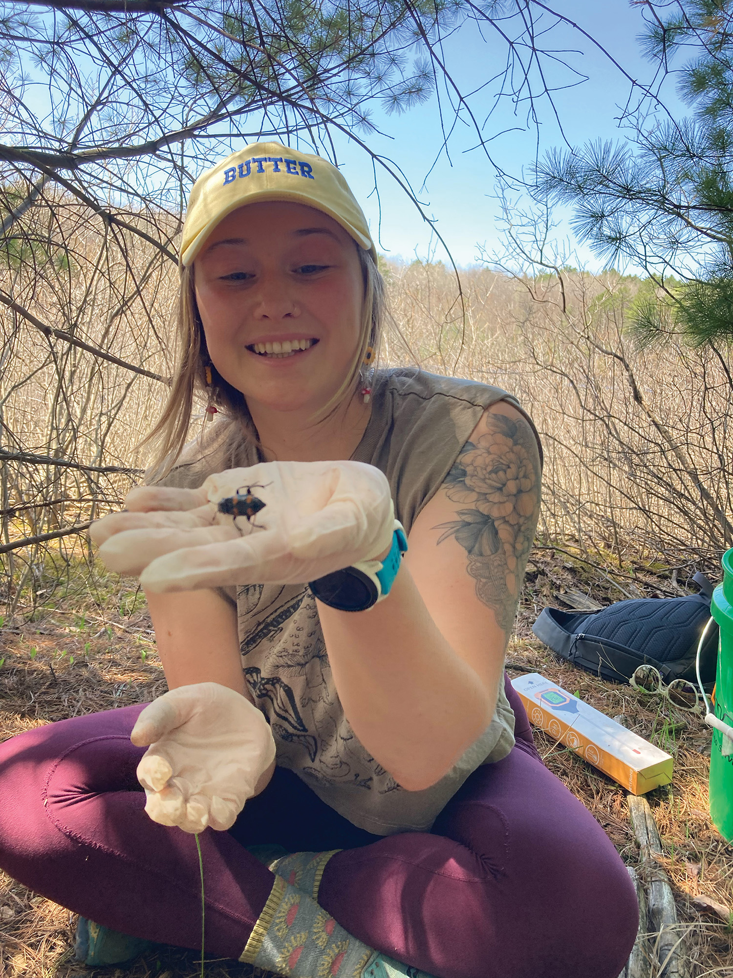 Student holding burying beetle in palm