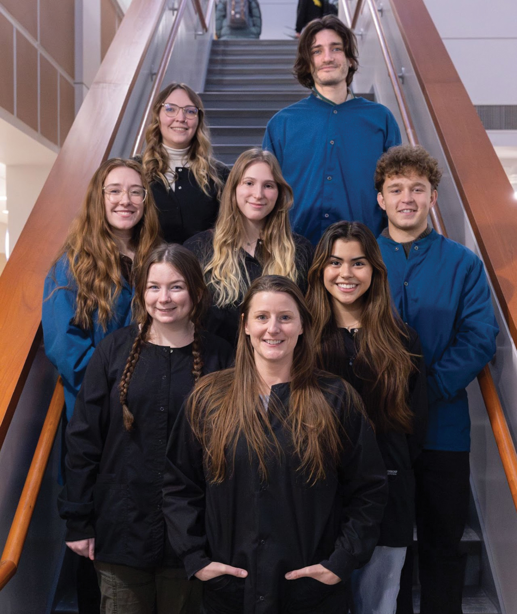 A group of NMU students and their professor pose on the stairs of the Science Building