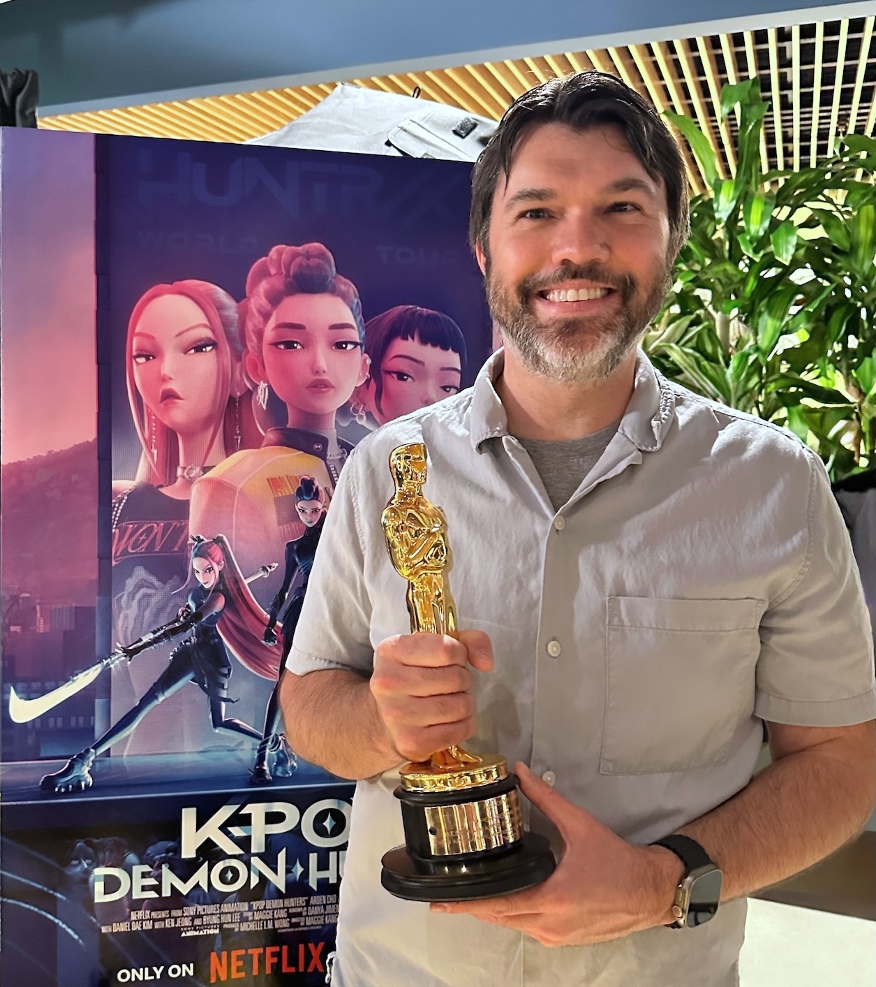 NMU Alumnus Gabe Thorburn holding an Oscar trophy for Best Animated Feature.