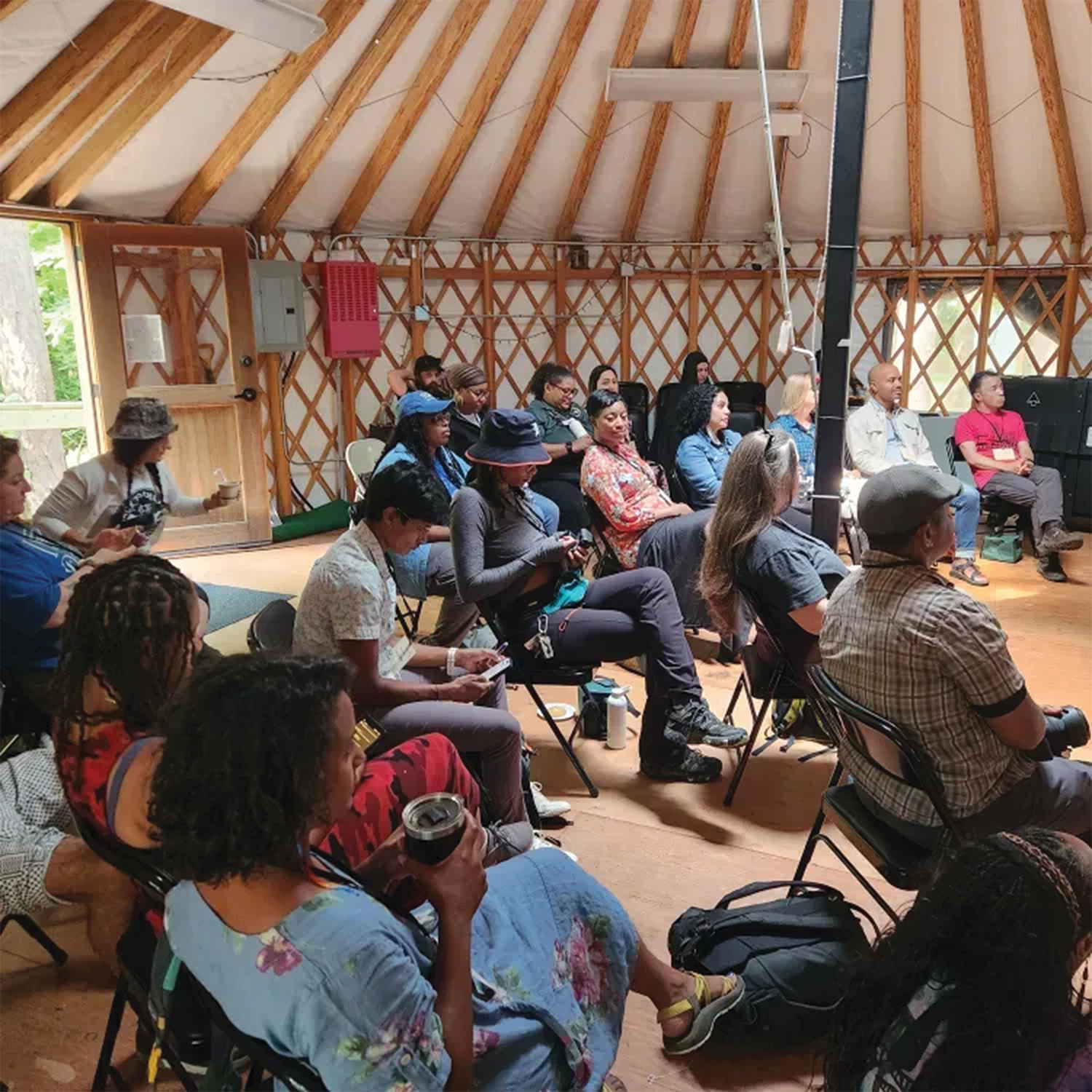 group of people inside light-filled yurt
