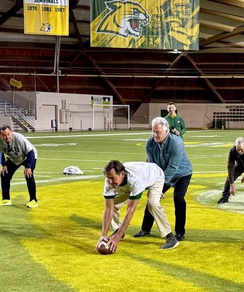 1975 football players on field running a play