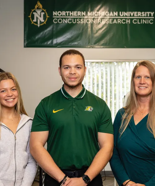 Students Natalie Molnau and Tyler Grant with Dr. Maggie Moore
