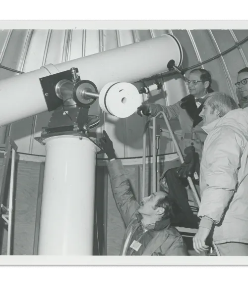 NMU President John X. Jamrich inspects the Sprinkle Memorial Telescope with physics professors Temple Smith, William Ralph and Robert Wagner.