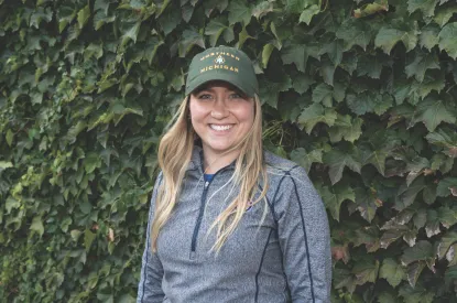 Emma with a Cubs shirt and NMU hat