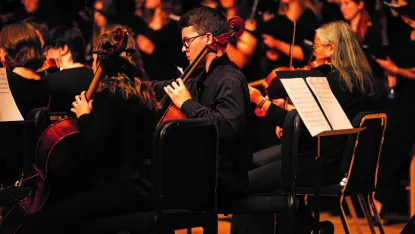 Students perform as a part of an orchestra