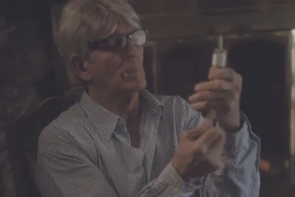 A man in a TV show holding a syringe