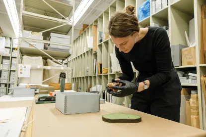 Sammie Hardewig gently handles a small Japanese figure from collection box