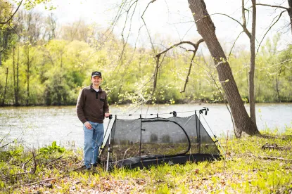 NMU alumni Evan BeVier standing next to the Trek-Tent Stargazer.