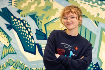 Sydney Kuipers in front of her mural.