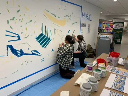 Students helping to paint the mural.