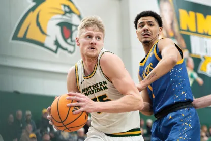 Dylan Kuehl standing next to an opponent during a basketball game.