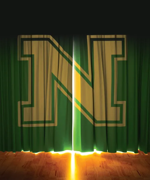 Green stage curtains with a large yellow-and-gold “N” slightly parted to reveal bright light on a wooden floor.