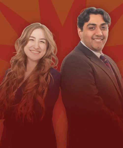 Cass McGregor and Dhruv C. Patel standing back to back in front of a red background.
