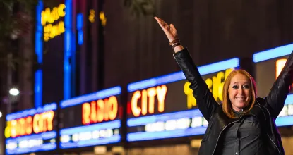Meg Schneider in front of New York's Radio City Music Hall