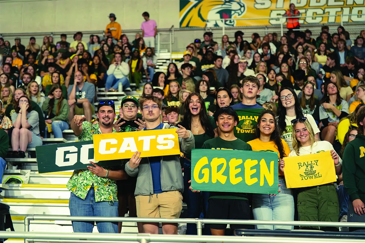 Crowd of students with Go Cats Green sign