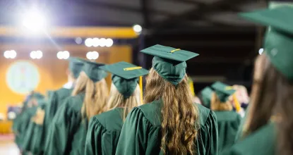 Students wearing their cap and gown during commencement