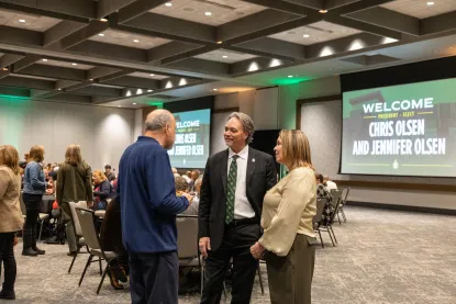 Dr. Olsen talking with NMU community members. 